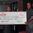 SBART_Photo SBART president Rich Hanna, left, accepts a check from Santa Barbara Bank & Trust for its sponsorship of the weekly press luncheons at Harry's.