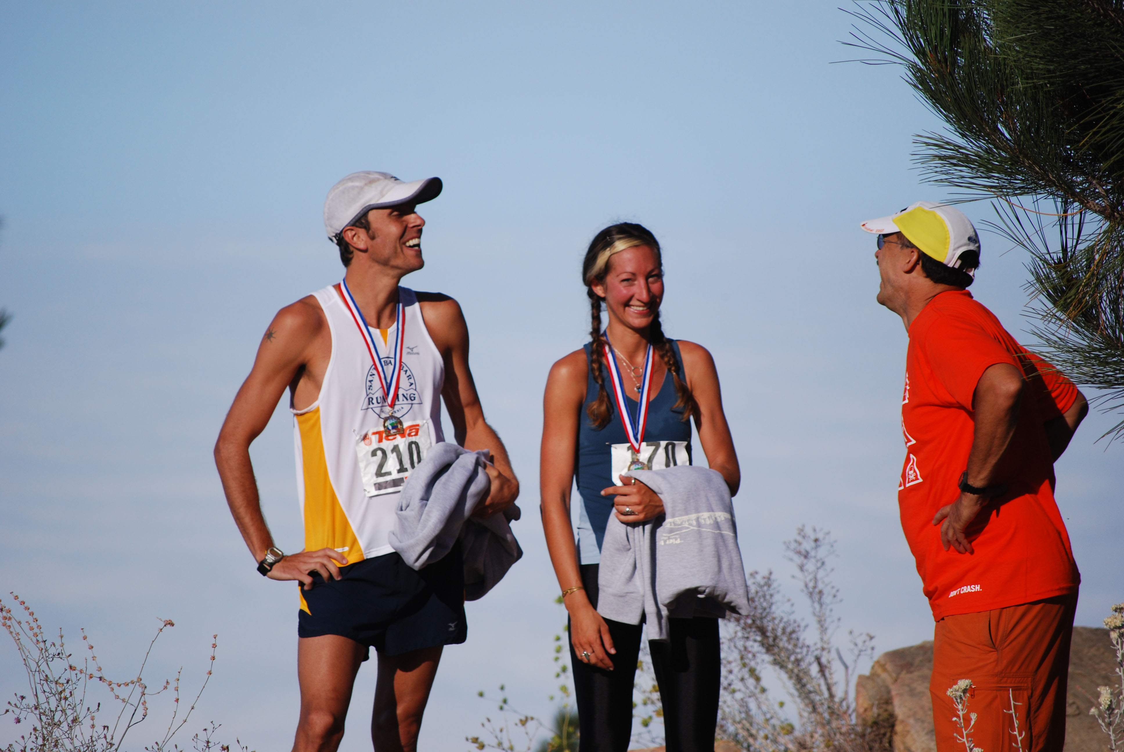 Men's winner Aaron Gillen, left, and women's winner Sara Dillman are all smiles shortly after completing the 13.1-mile climb that is the annual Pier-to-Peak Half-Marathon