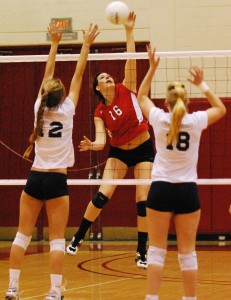 Maria Mayer hits between two Fullerton blockers on Tuesday night.