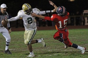 Santa Barbara quarterback R.J. Rosborough tries to fend off San Marcos defender Jake Buchanan