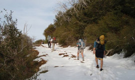 The troupe copes with a snow covered trail.