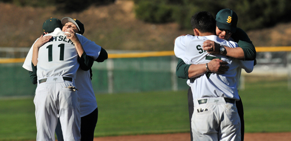 The parents of the late Simon Chavez, Ana and Luis, get hugs from Dons players Johnny Brontsema and Skyler Sabado.