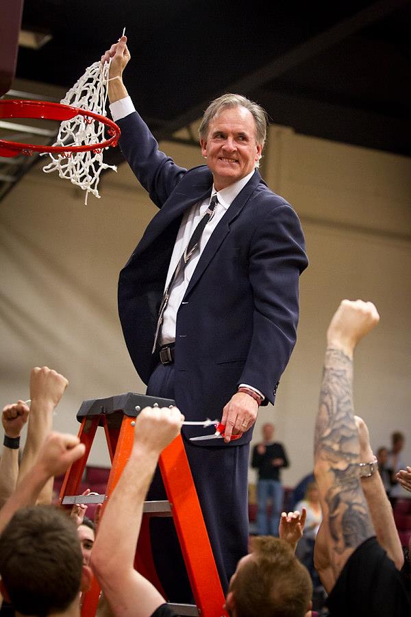 Westmont head coach John Moore cuts down the net after the Warriors clinched this year's regular-season GSAC Championship. (Brad Elliott Photo)