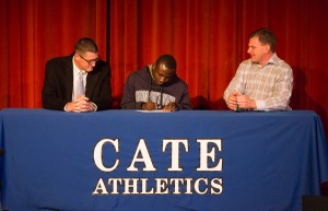 Joshua Yaro signs his National Letter of Intent on Wednesday with head coach Peter Mack on the left and assistant coach Jim Kane on the right. (Benjamin Morris Photo)