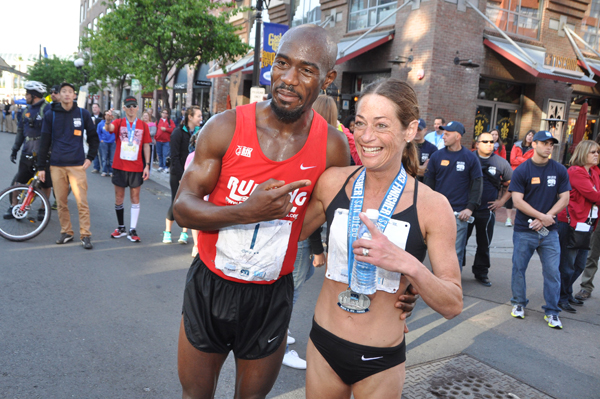 Female winner Joy Moats celebrates with Men's winner Okwaro Raura at the San Diego Half Marathon