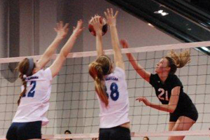 McKenna Goss (88) and Caroline Anderson (12) go up for a block