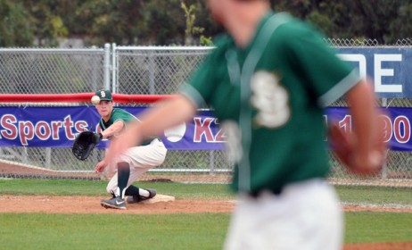 Dons third baseman Jeff Paschke (foreground) watches his throw reach the glove of first baseman Tyler Newman for an out in the sixth inning.