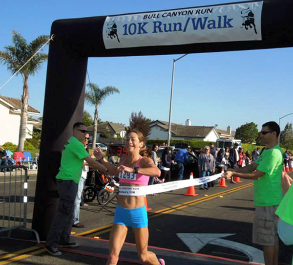 Santa Barbara's Joy Moats crossing the finish line in Bull Canyon with a 10k course record breaking time. 