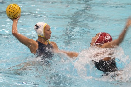 UCLA's Kodi Hill advances on goal guarded by 2012 Olympian Maggie Steffens