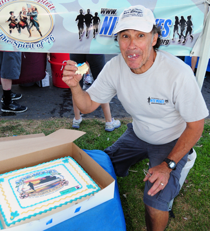 Jake Clinton takes a bite out a cake custom made to celebrate Nite Moves' 25th Anniversary. (Presidio Sports Photo)