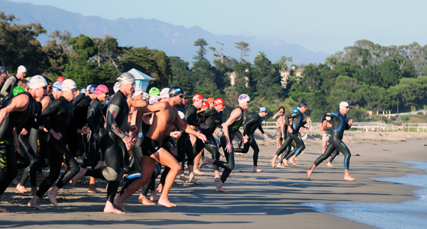 Ocean swimmers break for the ocean marking the beginning of Reef & Run's 5th season.