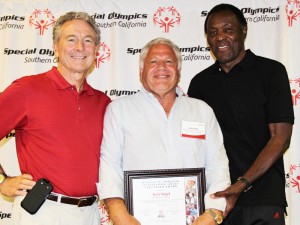 Jerry Siegel receives the Michael W. Harahan Outstanding Adult Volunteer Award from SOSC President/CEO Bill Shumard, left, and Founder of SOSC Rafer Johnson, right, at the annual SOSC Conference.