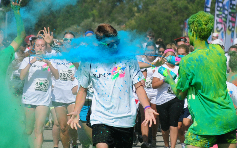 A runner takes a blast of dye to the face on Saturday.
