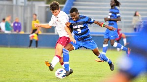 Fifi Baiden of UCSB tries to nudge a Westmont player off the ball during Saturday's exhibition match at Harder Stadium.