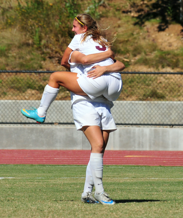 Holly leaps into the arms of teammate Kaci Mexico after scoring Westmont's final goal. Both players scored their second goal of the season in the match.