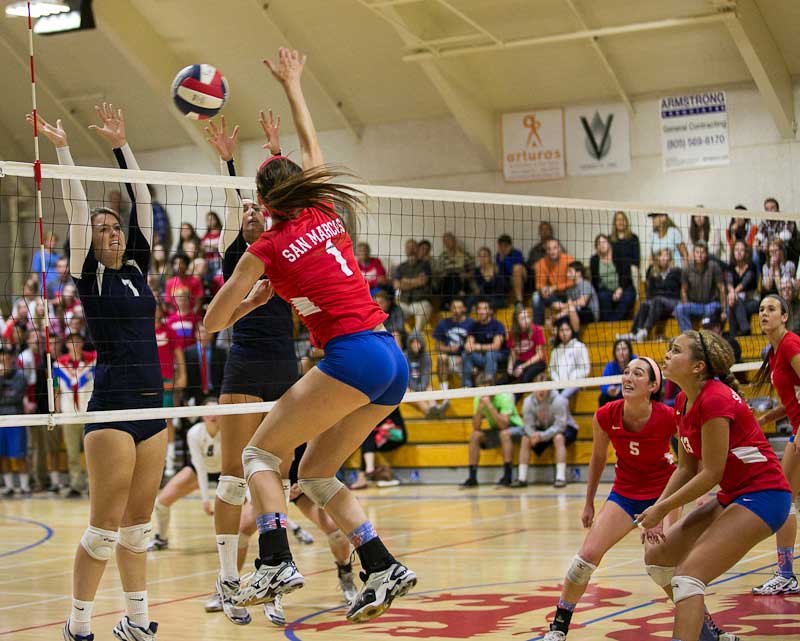 Anika Wilson spikes the ball off the Dos Pueblos block during the Royals' four-set win. (Wade Carr)