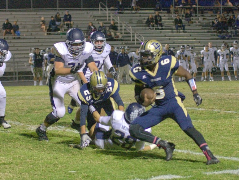 Leshon Bell of Dos Pueblos looks for running room against San Juan Hills. (Photo by Katie Issaris)