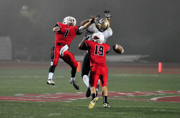 Bishop Diego's Anthony Carter, left, and Nunzio Billotti, right, break up a deep pass play by Mission Prep.