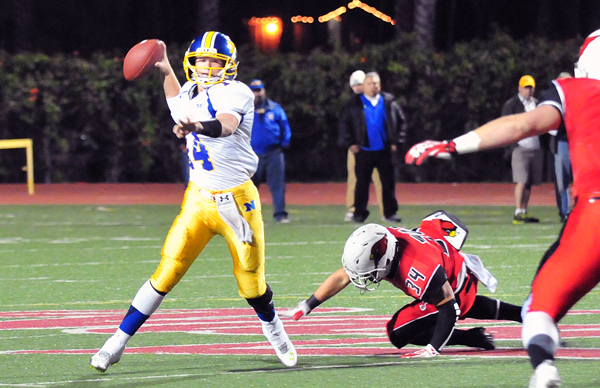 Nordhoff quarterback Tanner Workman eludes a Bishop Diego defender while looking for an open receiver.