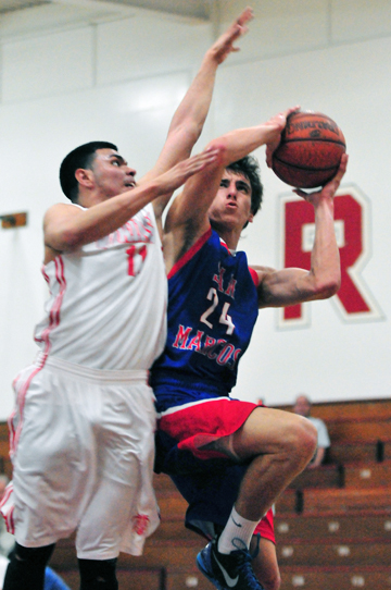 San Marcos' Bryce Ridenour drives to the basket while Hueneme's Josh Munoz defends.