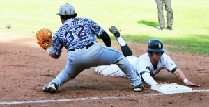 Ian True of the Dons slides safely into third base.