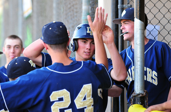 Luke Coffey returns to the Dos Pueblos dugout after scoring the game-winning run in the eighth inning.
