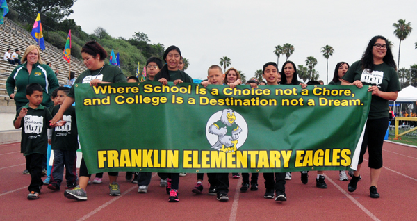 Each school marched behind a banner while getting cheered on by friends and family.