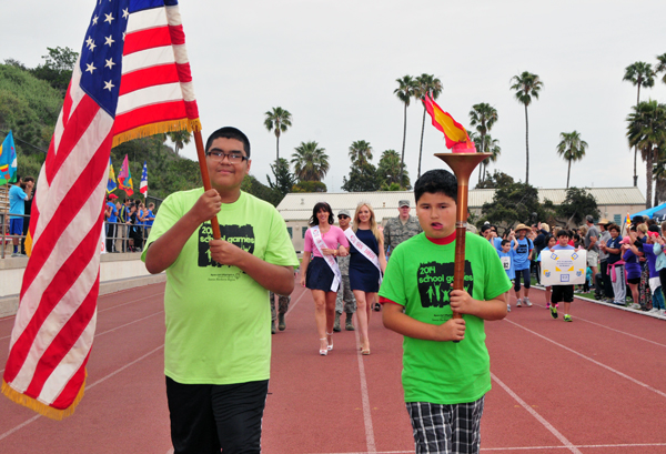 The American flag carrier and the torch bearer led the procession.