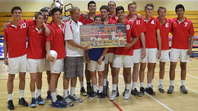 In honor of his 300th win as a volleyball coach, Roger Kuntz is presented a photo of his San Marcos team winning the Dos Pueblos Invitational.
