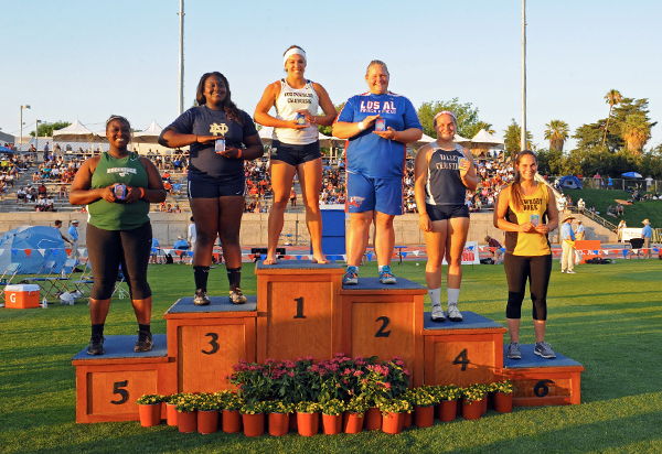Scarvelis stands atop the podium after winning her third CIF State Championship in shot put. (Leonard Coutin Photo)