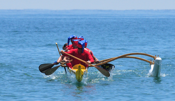 A canoe races towards the beach during one of Saturday's sprints.