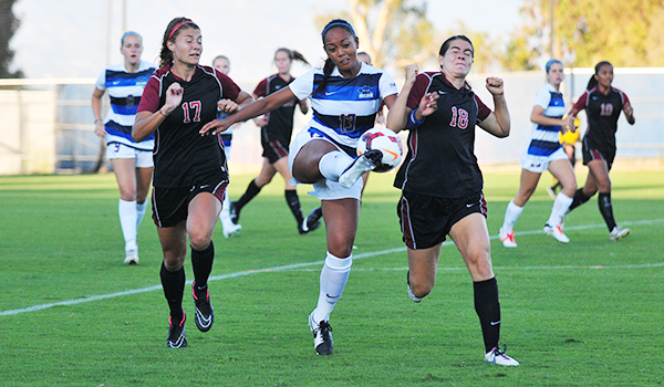 UCSB's Sydney Fuertes keeps the ball away from Westmont's Kelsey Steck, left, and Sophie Fuller, right.