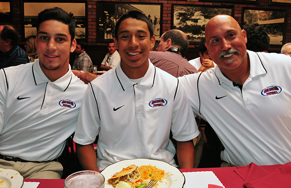 San Marcos' Russell Biolley, left, Inri Cortez, middle, and head coach Anthony Linebaugh, right.