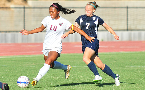 Westmont's Tiffany Dimaculangan and Concordia's Annika Hayman on Friday. Dimaculangan covered lots of ground in her full 90 minutes.