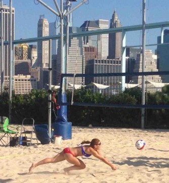 With the New York skyline in the background, Cassidy Drury-Pullen digs a ball during the AAU National Classic in Brooklyn Bridge Park.