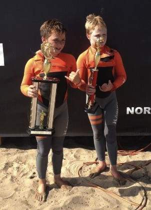 Twin brothers Hamilton, left, and Curtis Jacobs show the hardware they won at the NSSA Gold Coast Conference meet at C Street in Ventura.