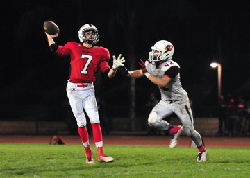 Carpinteria quarterback Jimmy Graves gets rid of a pass while being pressured by  Bishop Diego's Matt Shotwell.