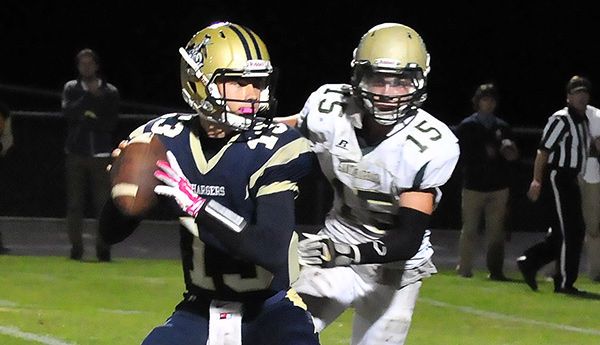 Santa Barbara's Carter Soto, who intercepted a pass and ran it back for a touchdown, pressures Dos Pueblos quarterback Barrett Burnes on a key play in overtime.