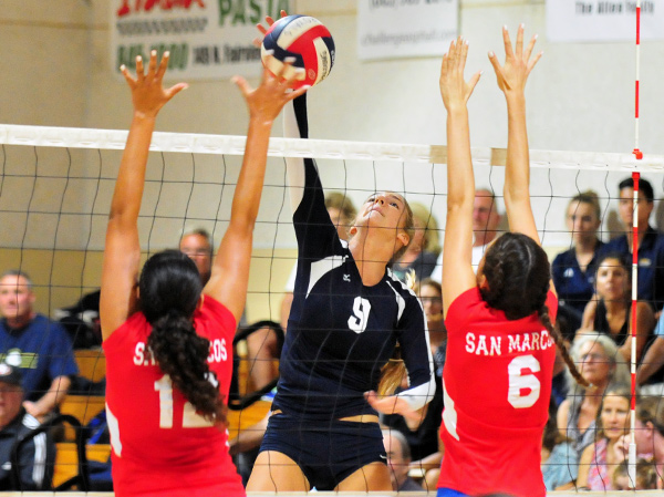 Natalie Klapp of Dos Pueblos tips over San Marcos blockers during the Chargers' five-set match victory at the Thunderhut. (Presidio Sports Photos)