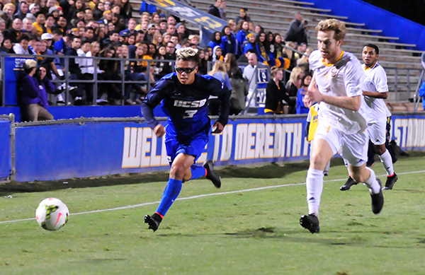 UCSB's Kevin Garcia-Lopez races down the sideline with Irvine's Matt Tilley. (Presidio Sports Photo)