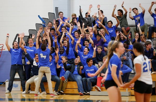 Cate's Blue Crew cheering section shows their support for the Rams volleyball team.