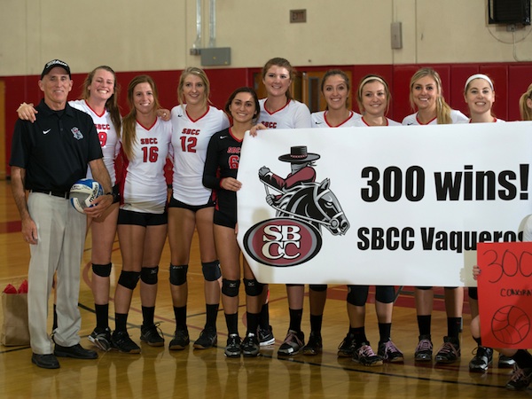 SBCC volleyball players celebrate with their coach, Ed Gover, after his 300th match victory.