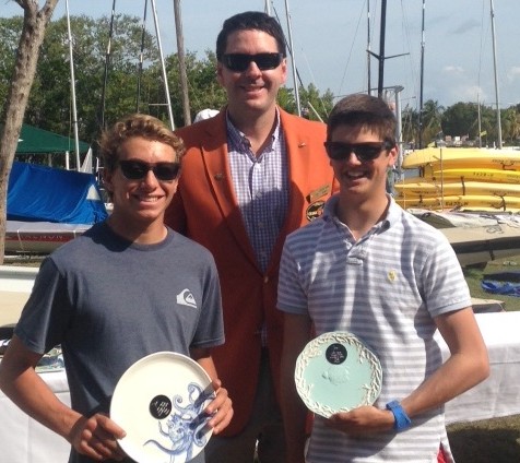 Orange Bowl 29er Class champions Jacob Rosenberg, left, and Evan Heffernan stand with Coconut Grove Yacht Club commodore Paul van Puffelen. 