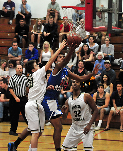San Marcos' Kele Mkpado drives to the hoop for a three-point play.