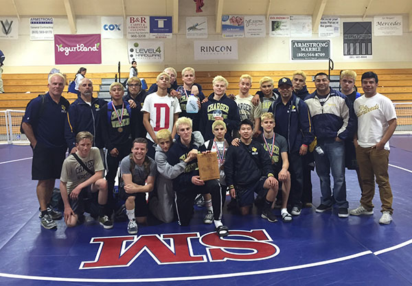 The Dos Pueblos wrestling team with its championship plaque. 