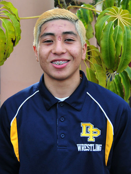 Dos Pueblos wrestle Gama Perez shows off his dyed blonde hair.