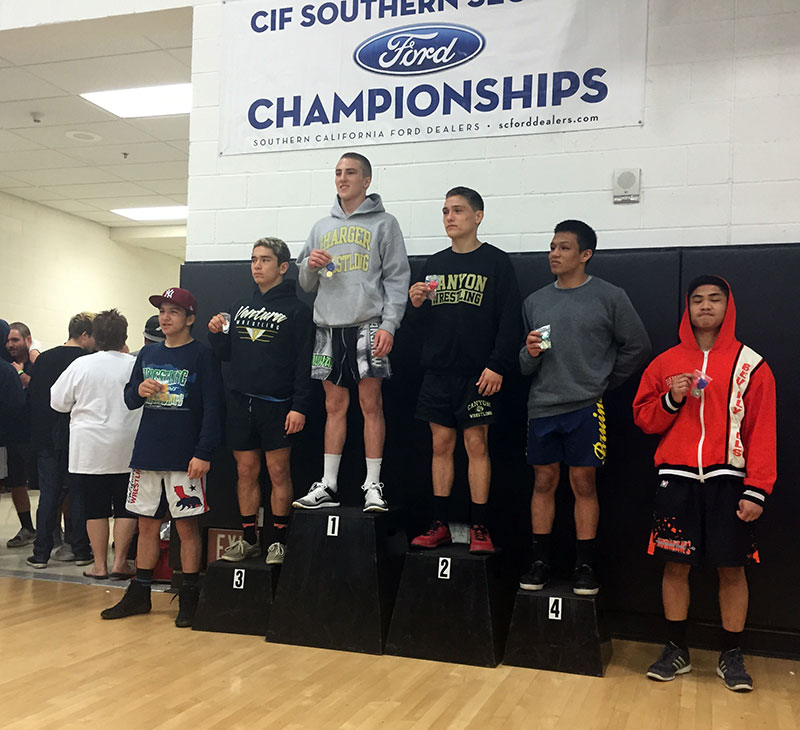 Cameron Cox stands on top of the podium for Dos Pueblos.