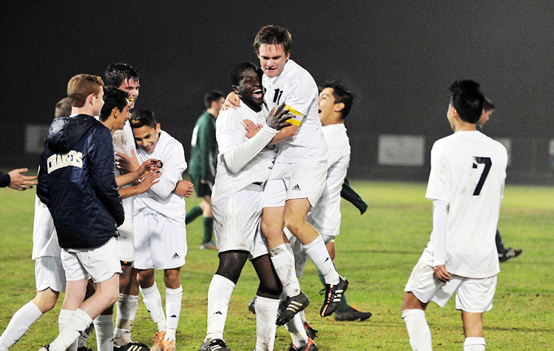 Drew Richard leaps into the arms of Manny Nwosu as the Chargers celebrate their victory on Tuesday. (Presidio Sports Photos)