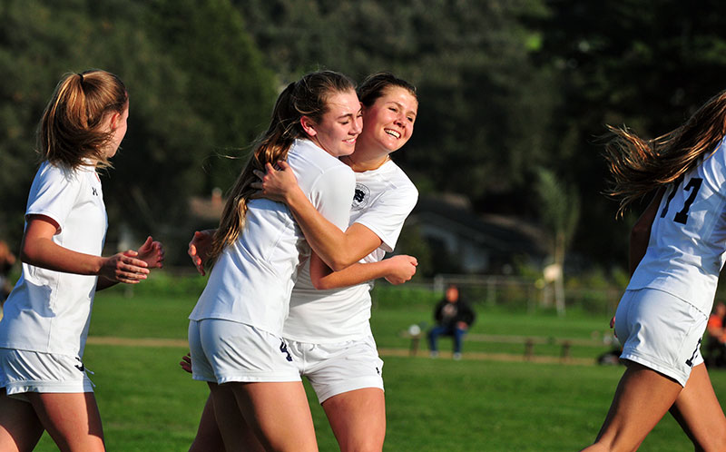 Phoebe Madsen gets a big hug after her throw-in  brushed past Hannah White and into the goal for Laguna Blanca's one goal on Thursday. 