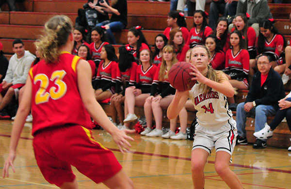 Carpinteria's Maddie Cleek gets set for a jump shot in front of Paraclete defender Michaela Reese.